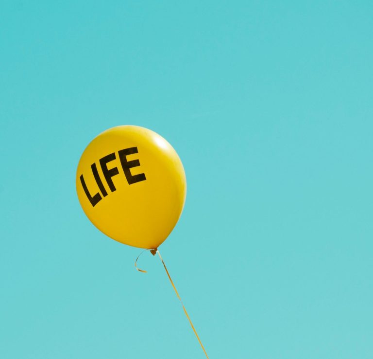 Change can lift you, even when it's unsettling Yellow balloon reading 'life' floating in the air, life transitions counselling Exeter